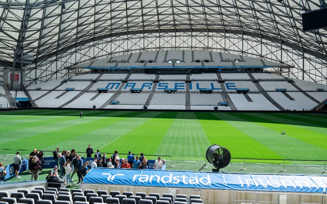 Guided tour group at the CEPAC Vélodrome in Marseille stadium.