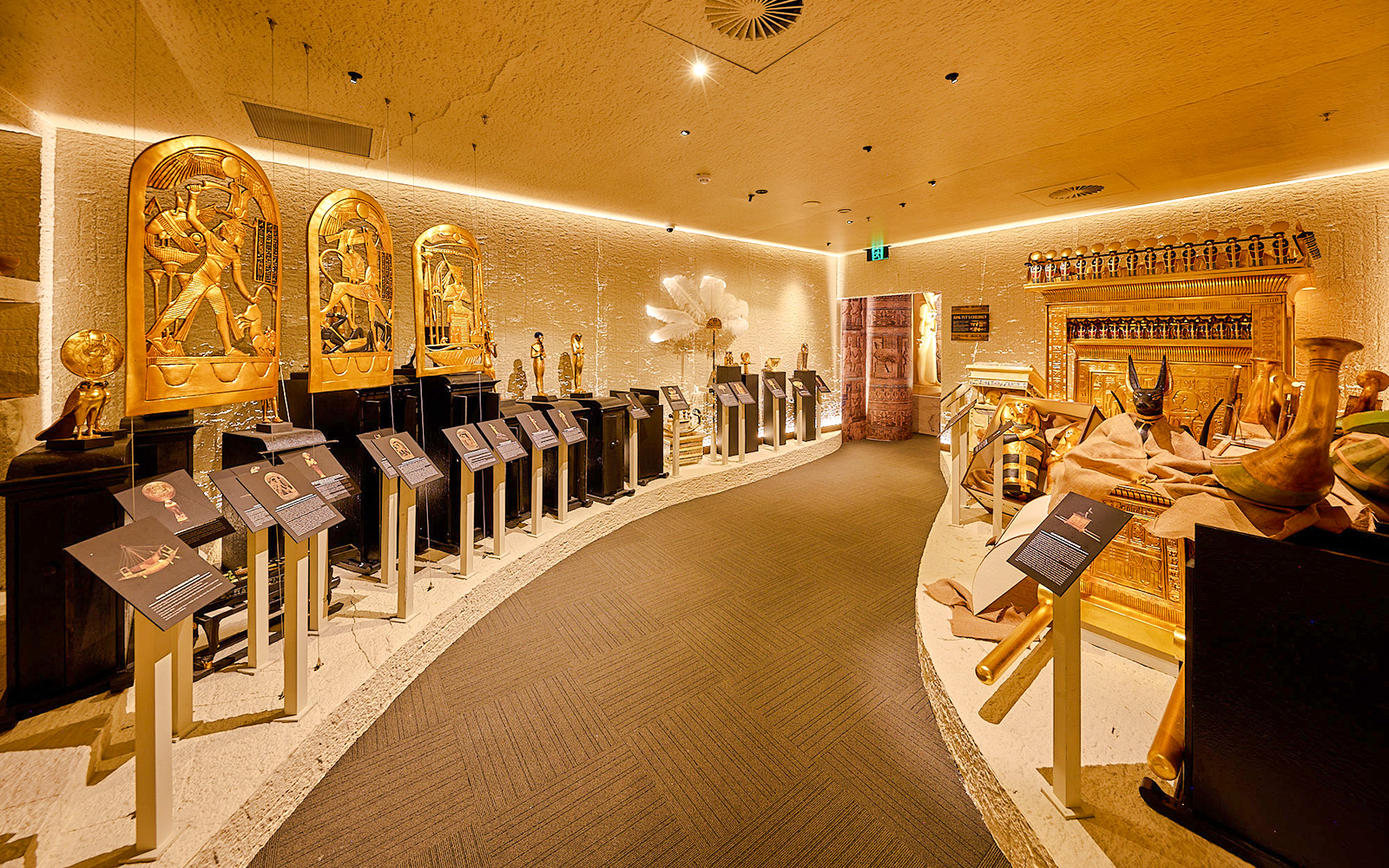 Golden Egyptian artifacts displayed in the Tomb of the Pharaoh exhibit room, Cairns.