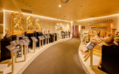 Golden Egyptian artifacts displayed in the Tomb of the Pharaoh exhibit room, Cairns.