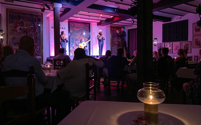 Flamenco performers on stage at Tablao El Arenal in Seville, Spain.