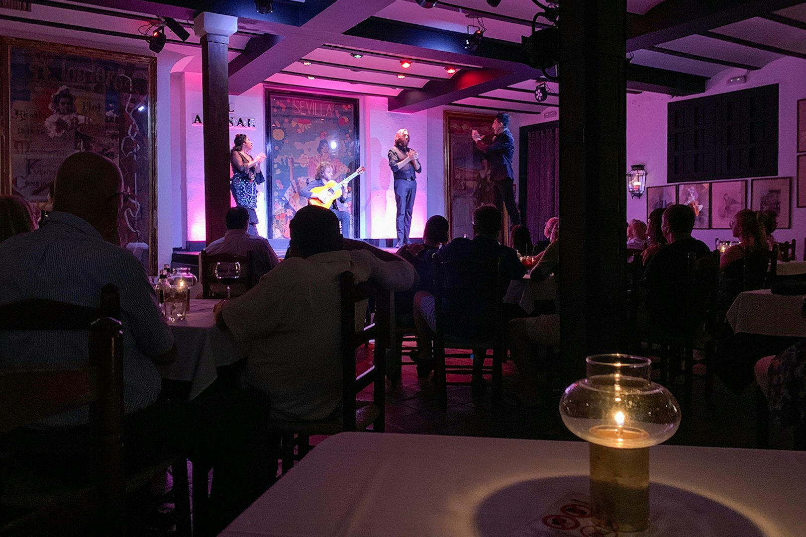 Flamenco performers on stage at Tablao El Arenal in Seville, Spain.