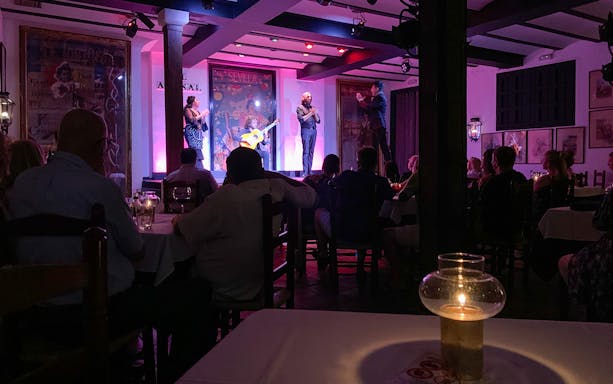Flamenco performers on stage at Tablao El Arenal in Seville, Spain.
