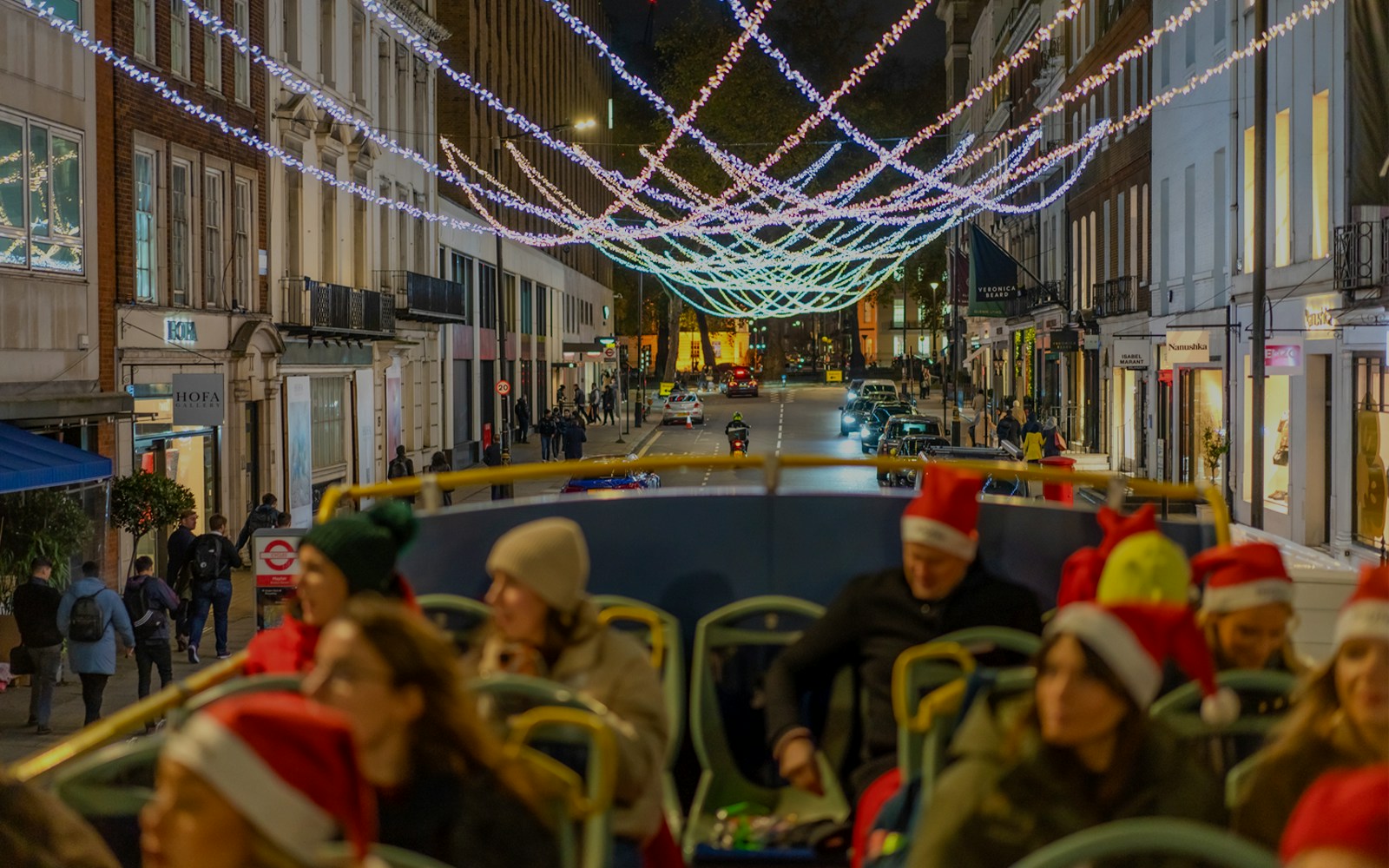 Double-decker bus touring London Christmas lights on Regent Street.