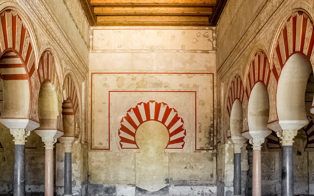 Interior arches and detailed wall design of Medina Azahara archaeological site.