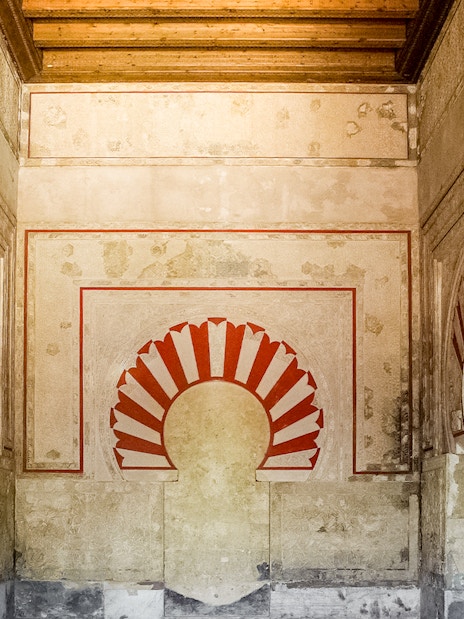 Interior arches and detailed wall design of Medina Azahara archaeological site.