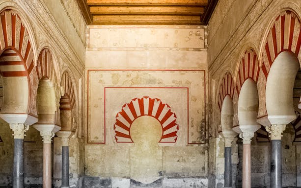 Interior arches and detailed wall design of Medina Azahara archaeological site.
