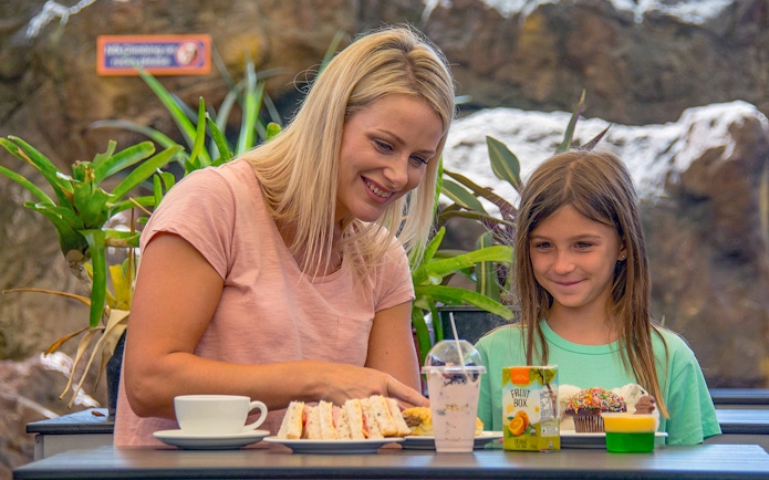 Mother and daughter enjoying snacks at SEA LIFE Sunshine Coast café.