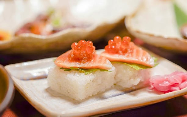 Sushi topped with salmon and roe on a Kyoto night foodie tour.