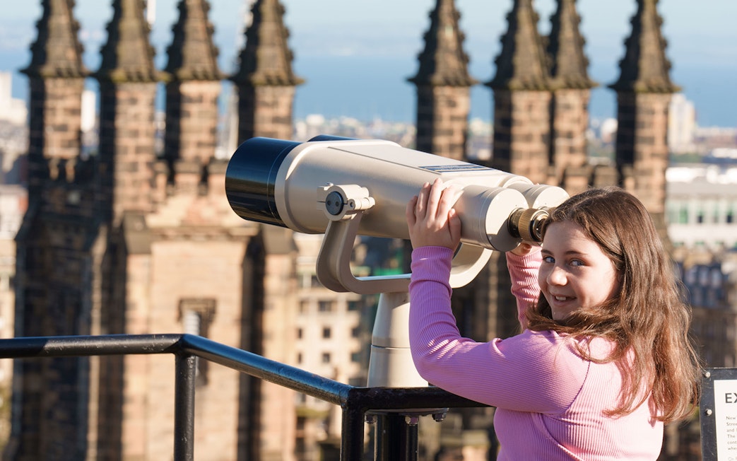 Young visitor using telescope at Camera Obscura & World of Illusions, Edinburgh.