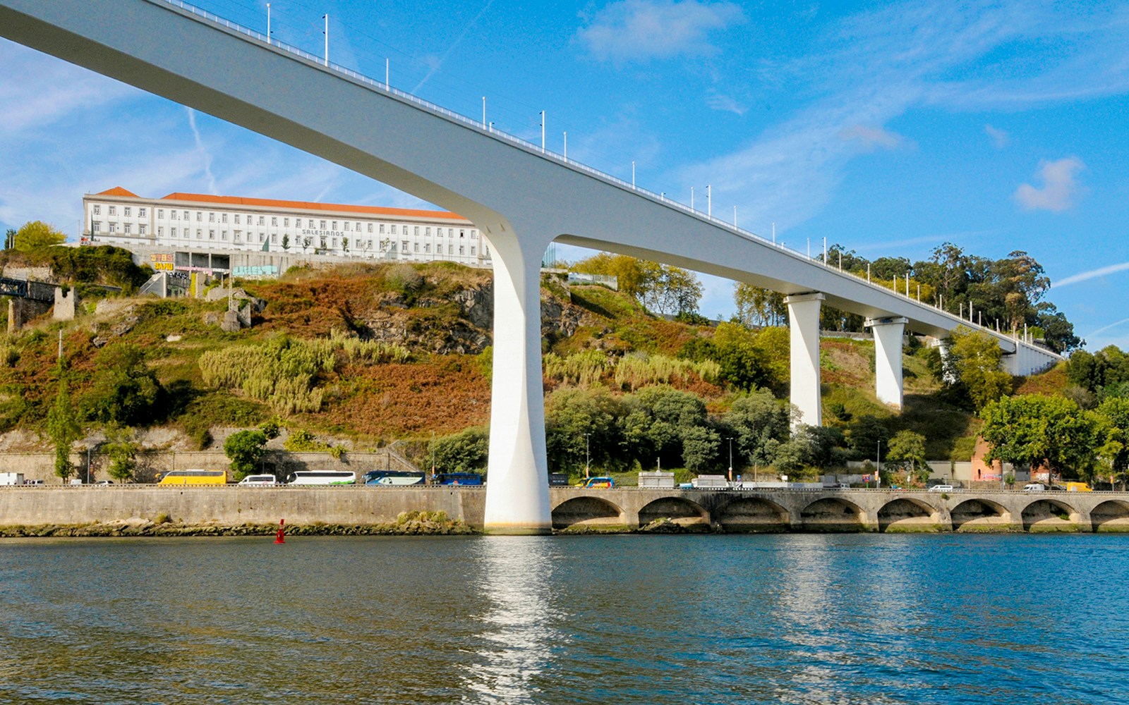 St. John's Bridge spanning the Douro River in Porto, Portugal, with hillside view.