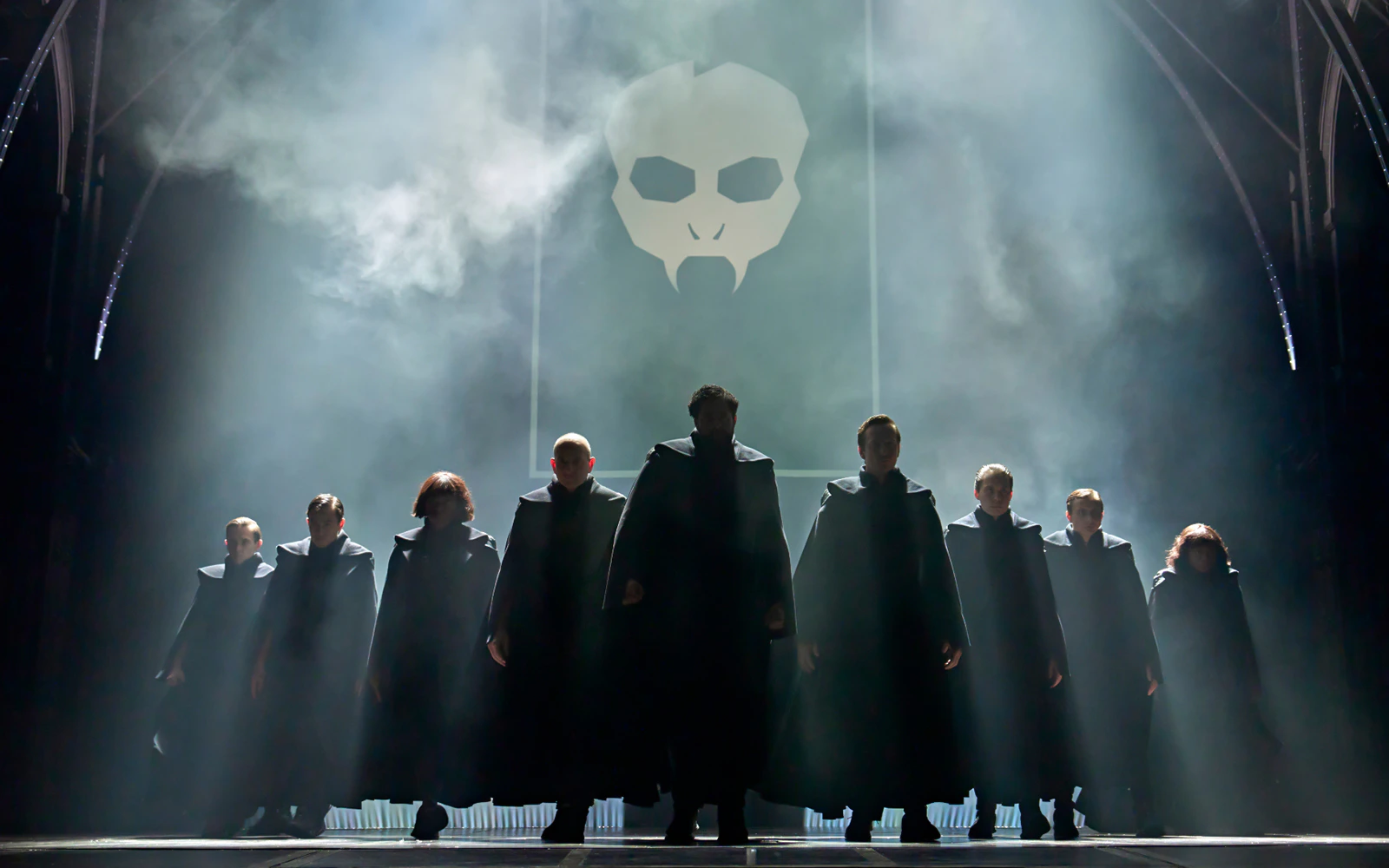 Cast members in dark robes on stage during "Harry Potter and the Cursed Child" performance.