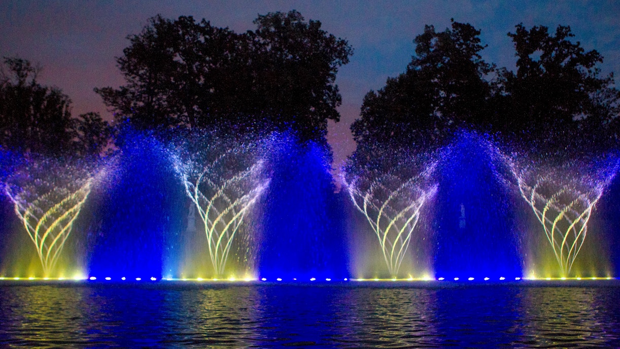 Musical Fountain show with illuminated water jets at Versailles Gardens.