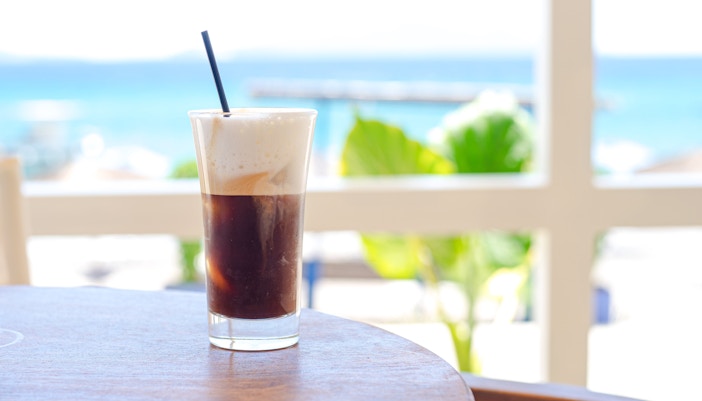 Freddo cappuccino on a table at Delphi Restaurant with sea view.