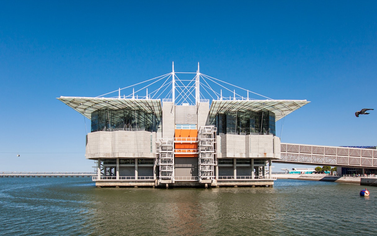 Lisbon Oceanarium building on water with clear blue sky, Portugal.
