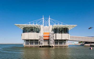 Lisbon Oceanarium building on water with clear blue sky, Portugal.