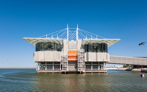 Lisbon Oceanarium building on water with clear blue sky, Portugal.
