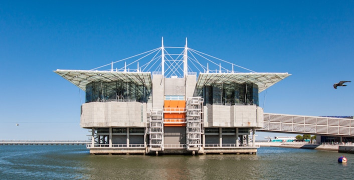 Lisbon Oceanarium building on water with clear blue sky, Portugal.