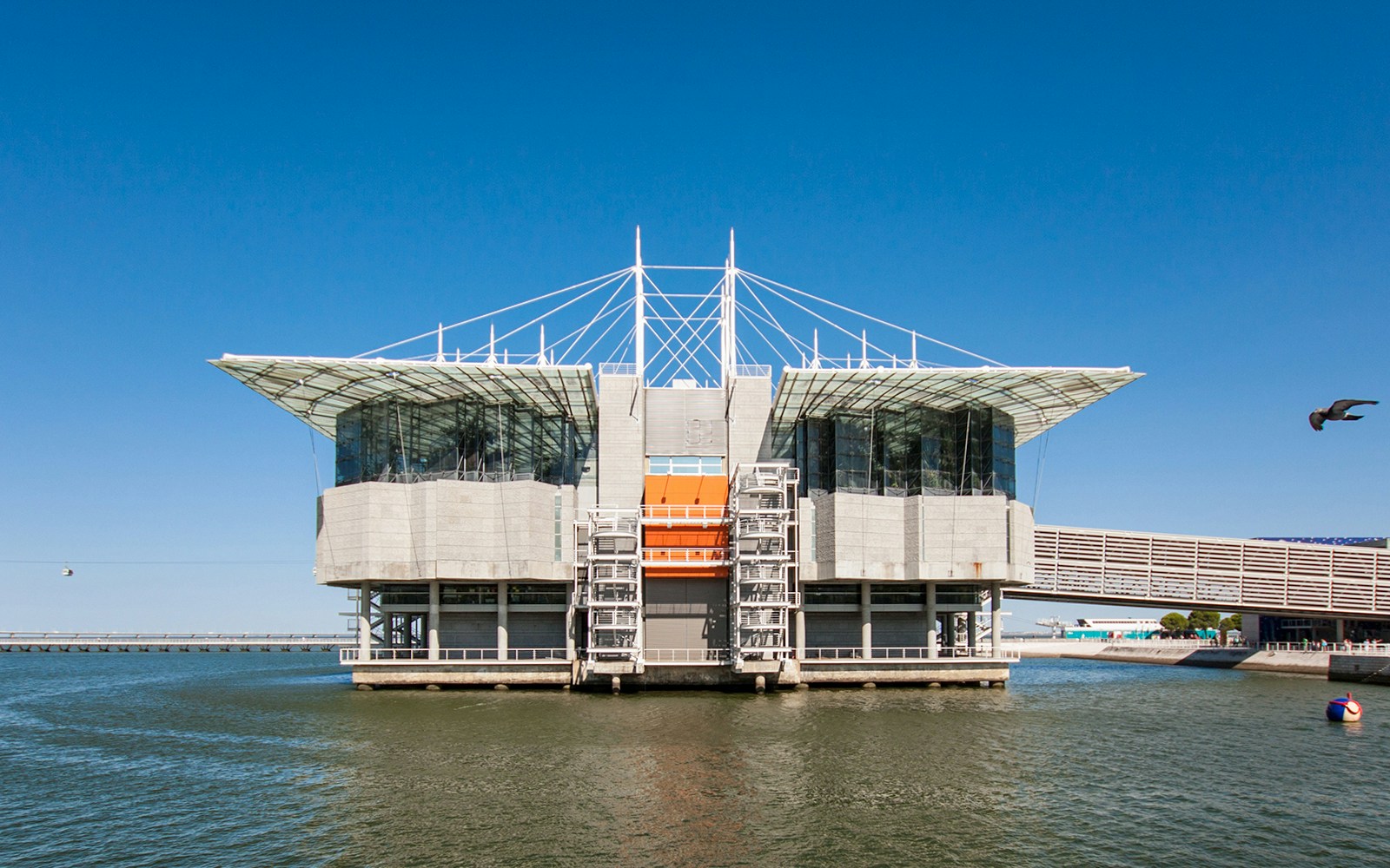 Lisbon Oceanarium building on water with clear blue sky, Portugal.