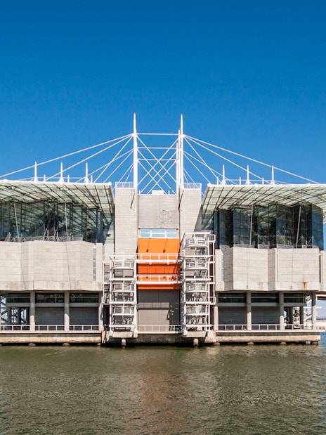 Lisbon Oceanarium building on water with clear blue sky, Portugal.