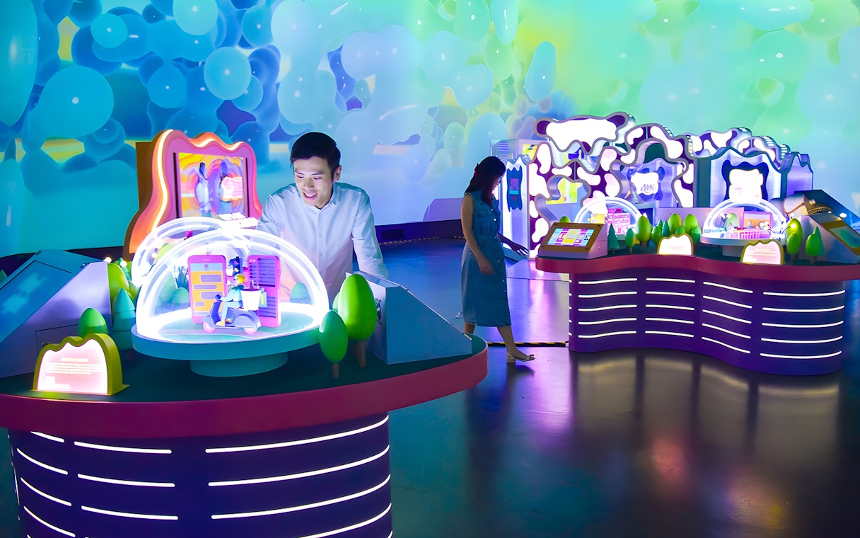 Interactive exhibit at Science Centre Singapore with colorful displays and visitors exploring.