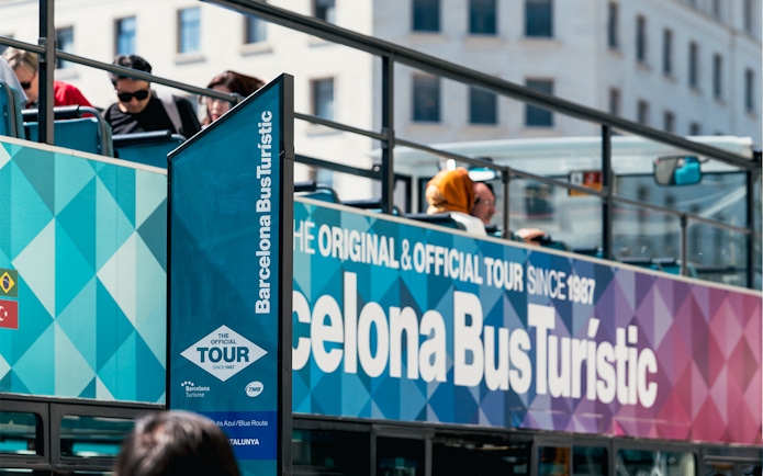 Barcelona Bus Turistic with passengers on an open-top bus tour.
