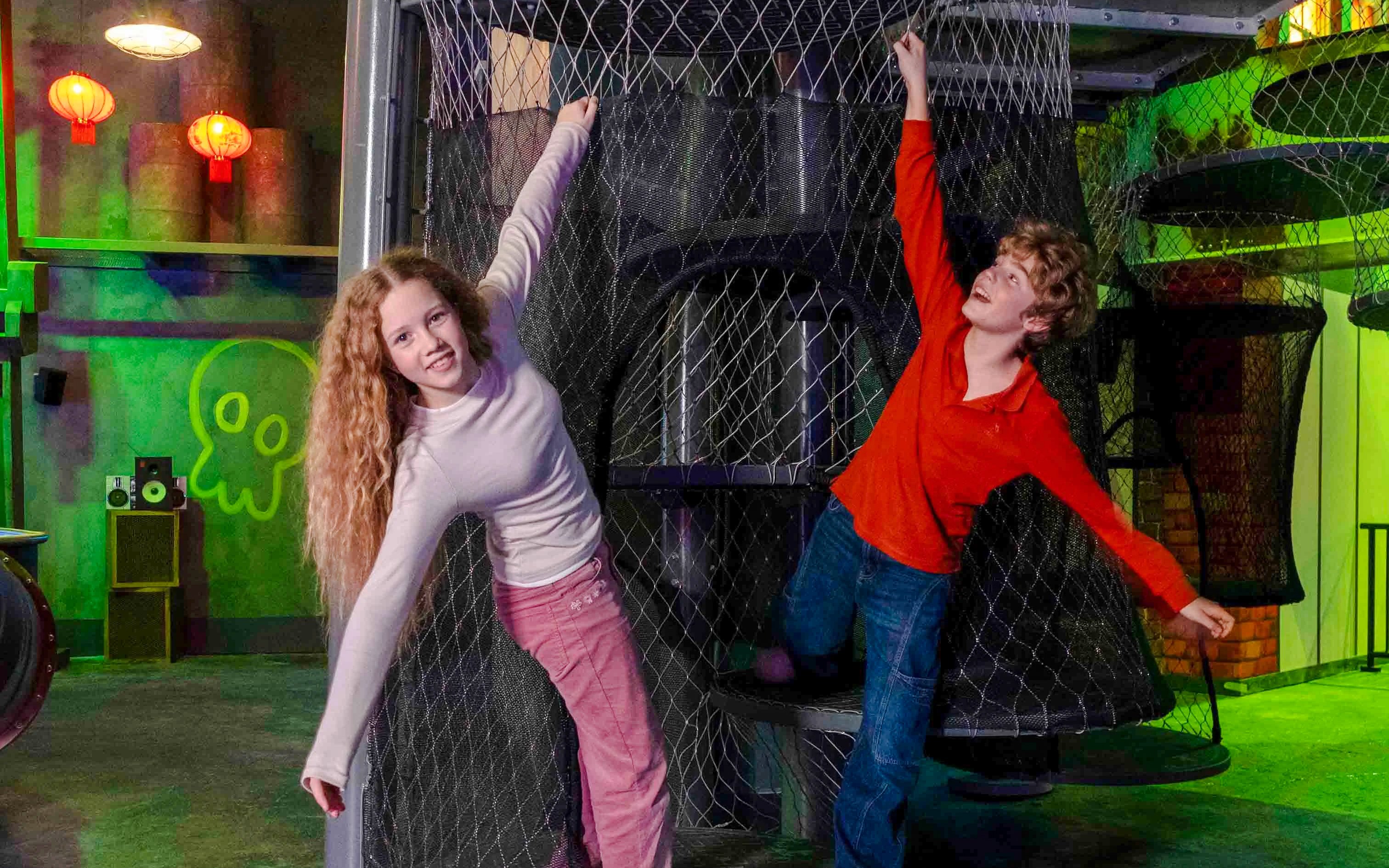 Children playing on a netted climbing structure at Nickelodeon Play City, Istanbul.