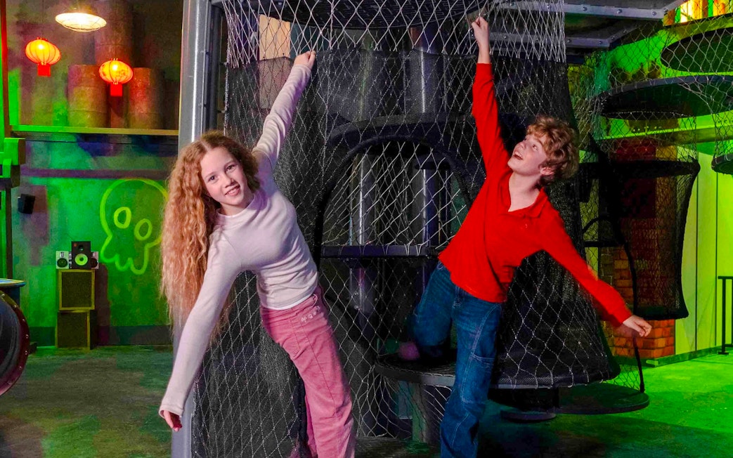 Children playing on a netted climbing structure at Nickelodeon Play City, Istanbul.