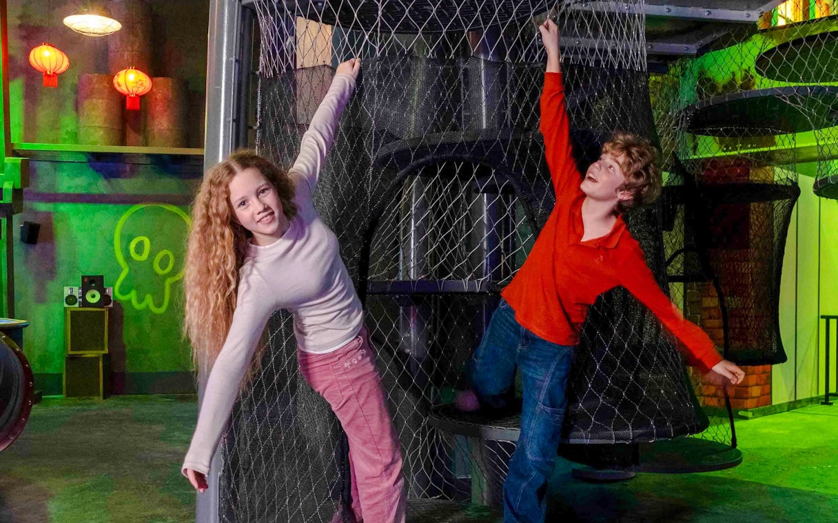 Children playing on a netted climbing structure at Nickelodeon Play City, Istanbul.