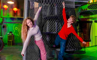 Children playing on a netted climbing structure at Nickelodeon Play City, Istanbul.