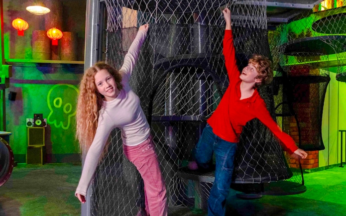 Children playing on a netted climbing structure at Nickelodeon Play City, Istanbul.