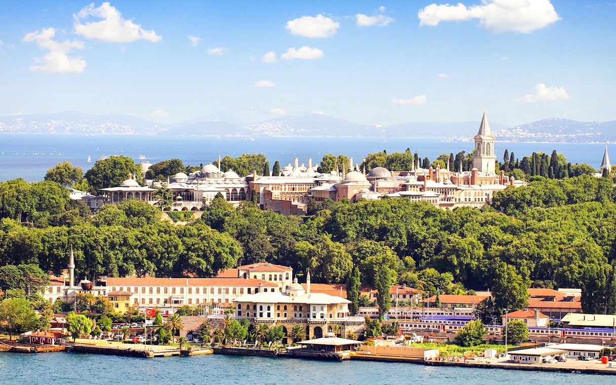 Topkapi Palace surrounded by lush greenery with the Bosphorus in the background, Istanbul.