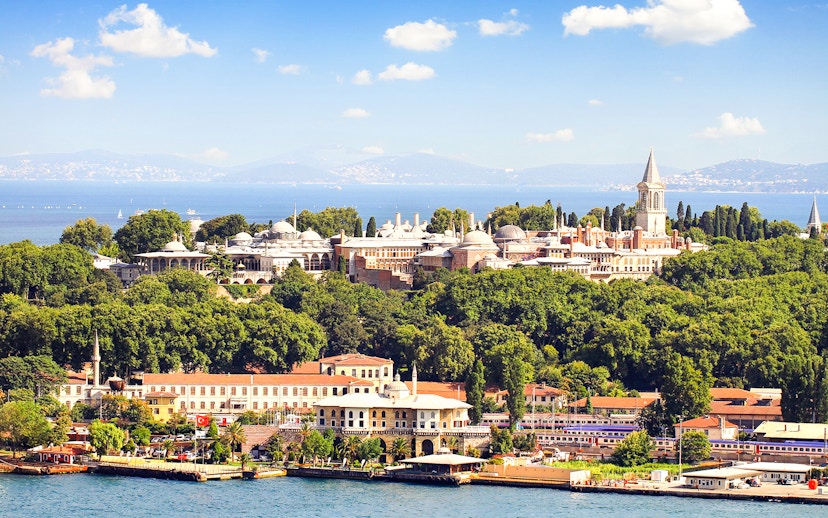 Topkapi Palace surrounded by lush greenery with the Bosphorus in the background, Istanbul.