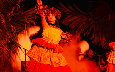 Performer in traditional attire at Mauka Warriors Luau, Hawaii.