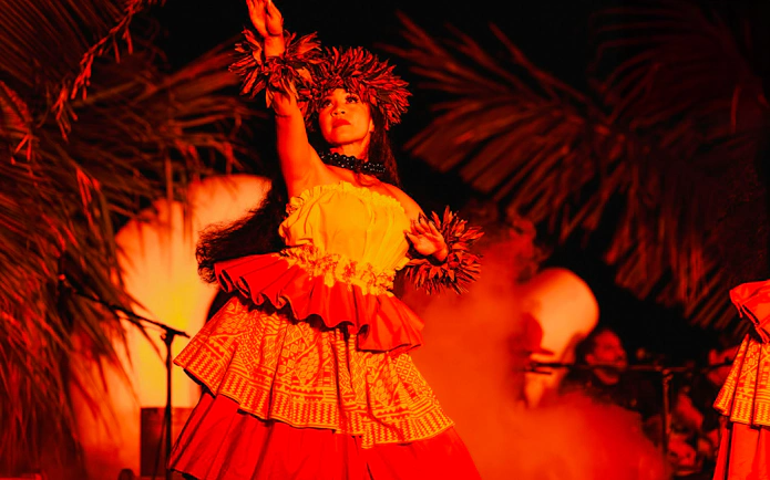 Performer in traditional attire at Mauka Warriors Luau, Hawaii.