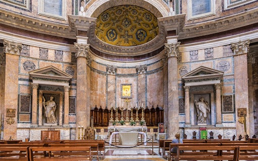 Pantheon altar in Rome with ornate columns and religious statues.