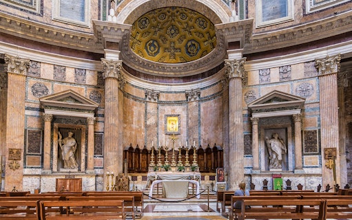 Pantheon altar in Rome with ornate columns and religious statues.