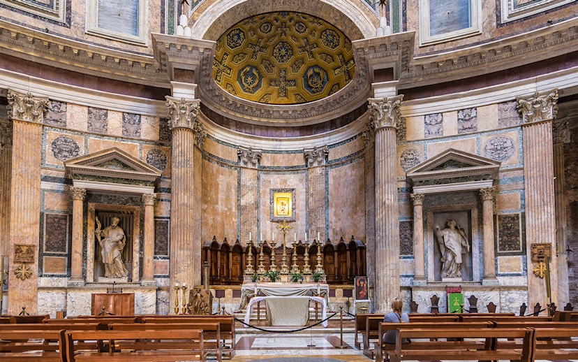 Pantheon altar in Rome with ornate columns and religious statues.