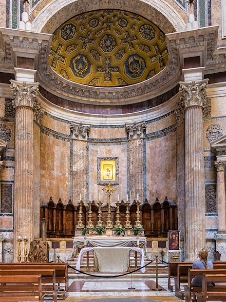Pantheon altar in Rome with ornate columns and religious statues.