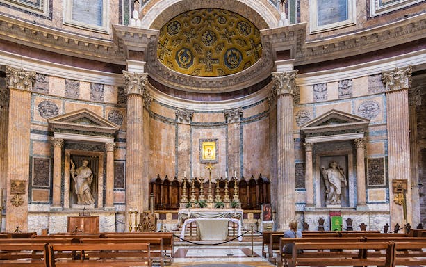Pantheon altar in Rome with ornate columns and religious statues.