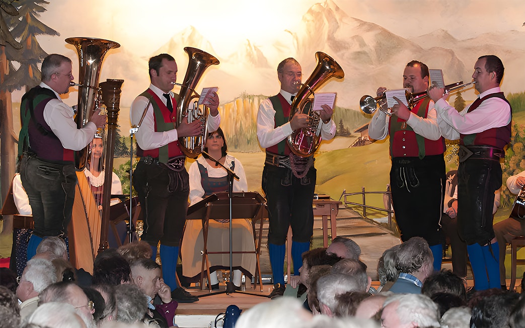 Musicians in traditional attire perform at Tyrolean Evening Folk Show with the Gundolf Family.