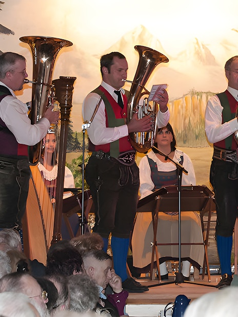 Musicians in traditional attire perform at Tyrolean Evening Folk Show with the Gundolf Family.