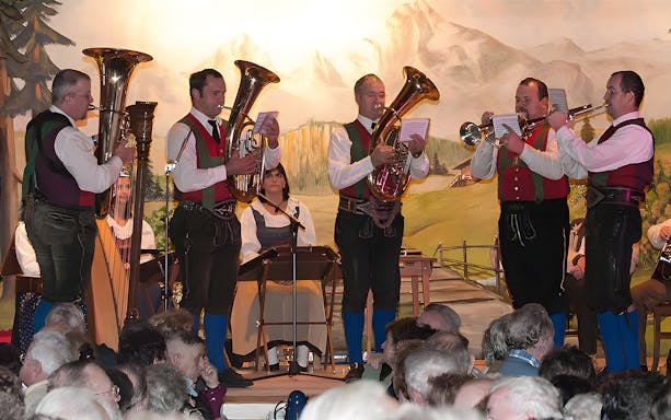 Musicians in traditional attire perform at Tyrolean Evening Folk Show with the Gundolf Family.
