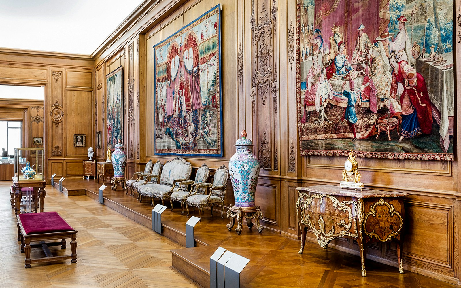 Petit Palais interior with ornate tapestries and antique furniture, Paris.