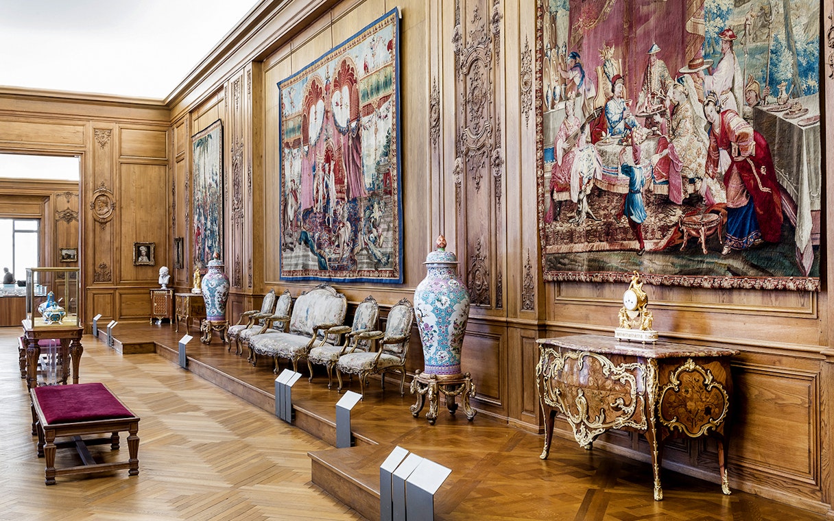Petit Palais interior with ornate tapestries and antique furniture, Paris.