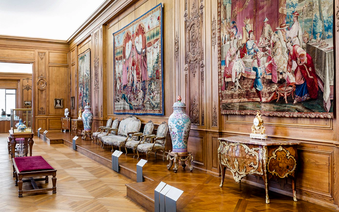 Petit Palais interior with ornate tapestries and antique furniture, Paris.