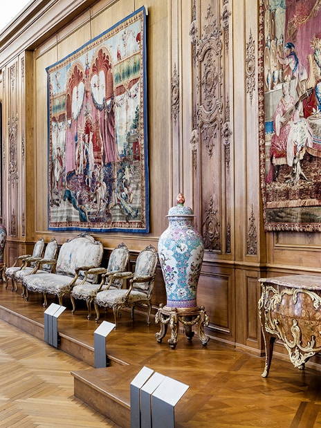 Petit Palais interior with ornate tapestries and antique furniture, Paris.
