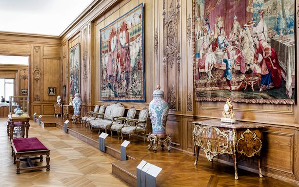 Petit Palais interior with ornate tapestries and antique furniture, Paris.