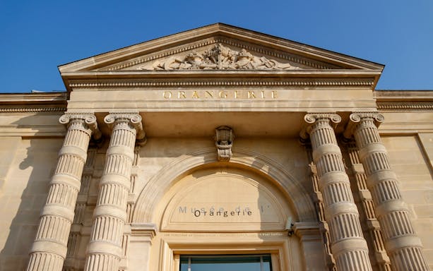 Exterior facade of the Orangerie Museum in Paris with classical columns.