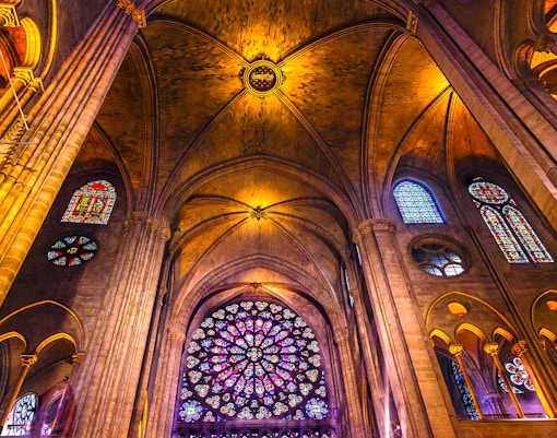 Notre-Dame Cathedral facade with tourists using audio guides in Paris.