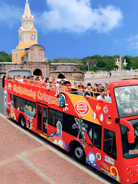 Open-top tour bus in Cartagena passing by the iconic Clock Tower.